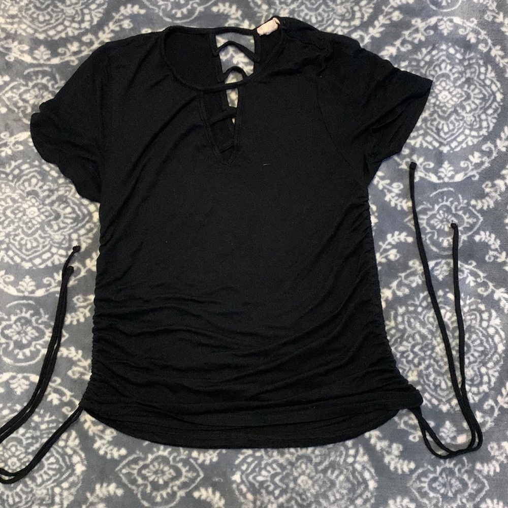 A black shirt with cut outs on front and back
